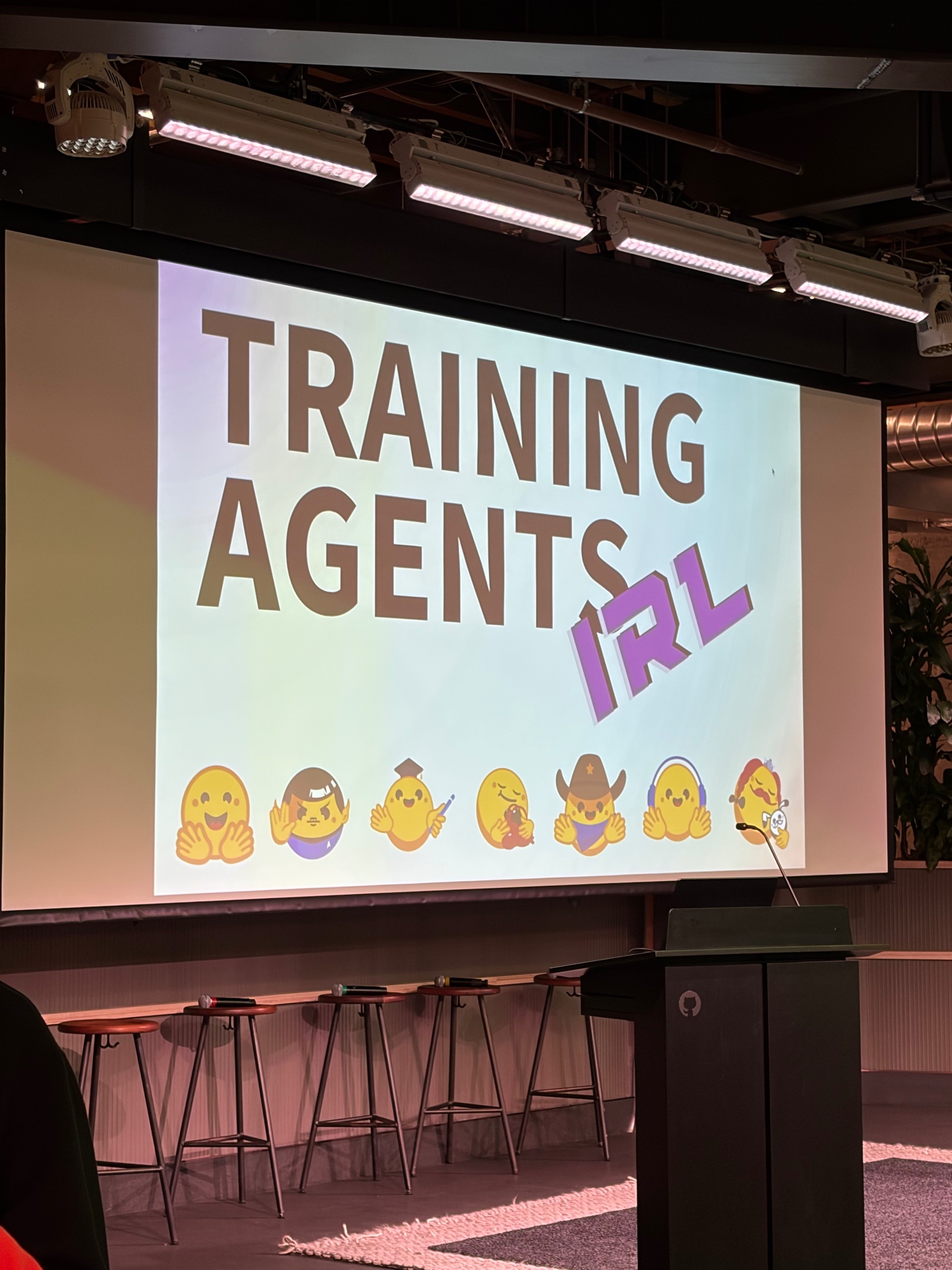 The Training Agents IRL presentation screen at GitHub in San Francisco.