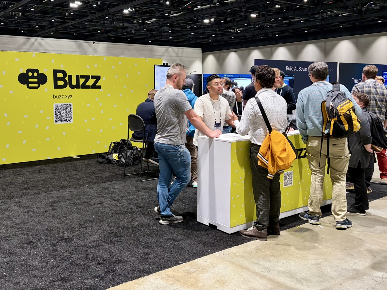 The Buzz team talking with attendees at the conference showcase.