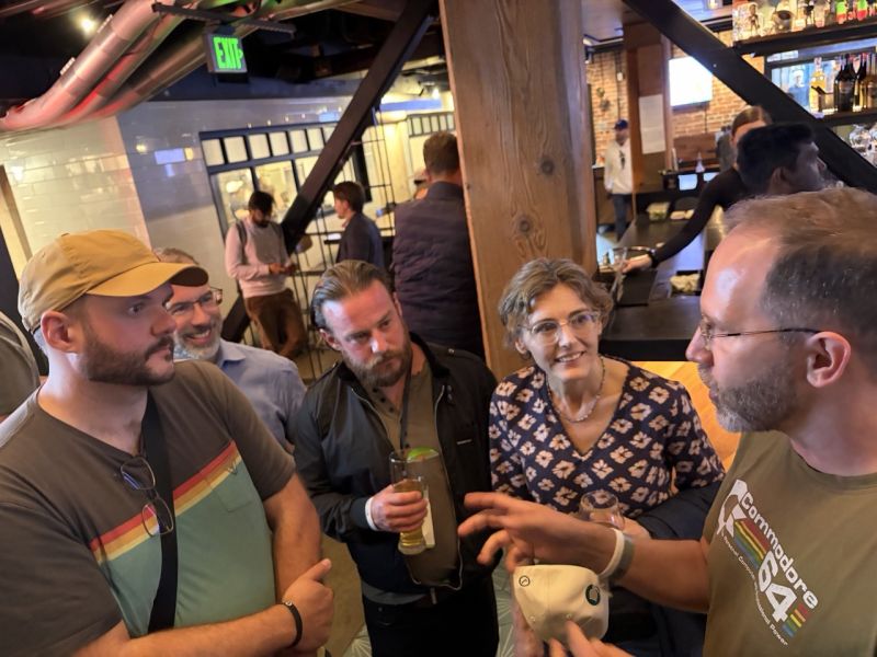 OpenClaw maintainers and attendees talking during the after-hours event at GitHub.