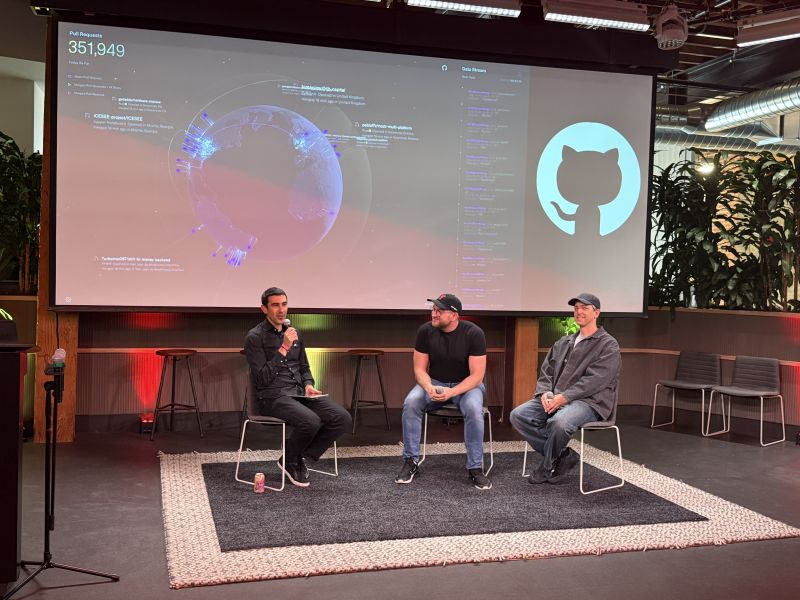 Panelists seated on stage at GitHub with OpenClaw visuals on the screen.