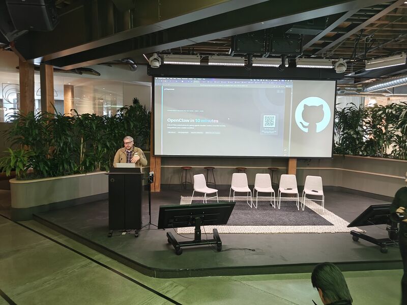 Brad Groux on stage with an OpenClaw in 10 minutes slide behind him at GitHub.